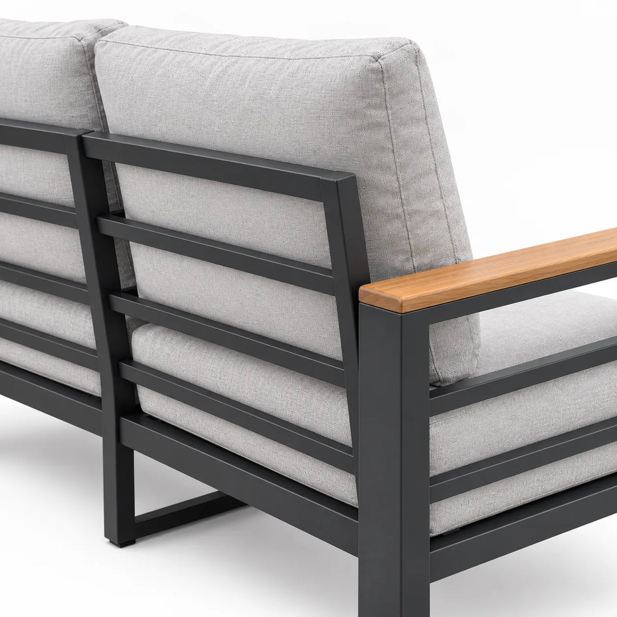 Rear three-quarter view of an outdoor aluminum patio 3-seat sofa with light gray cushions and dark gray aluminum frame