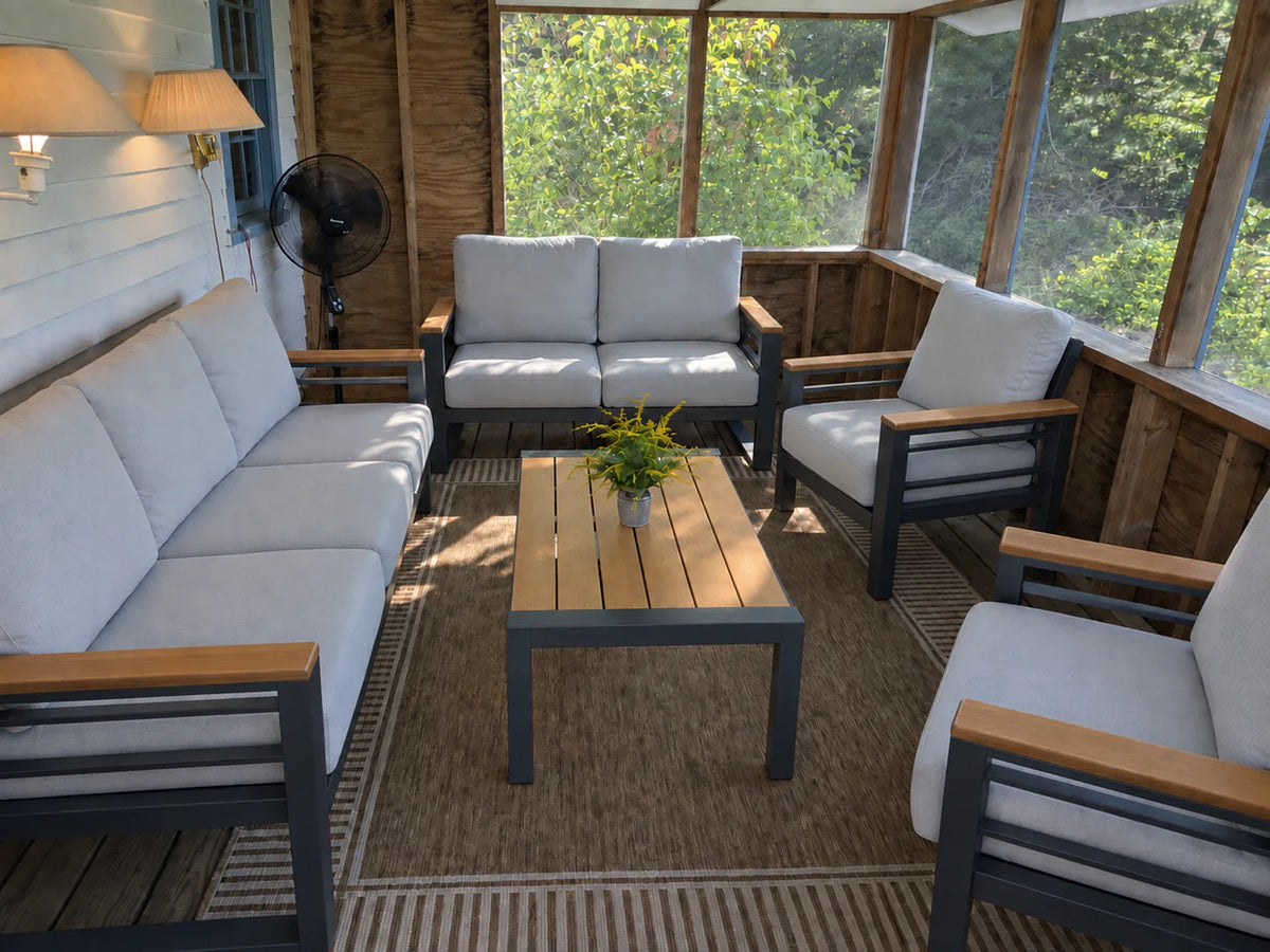 Five-piece outdoor patio furniture set with a sofa, loveseat, two armchairs, and coffee table on a screened porch