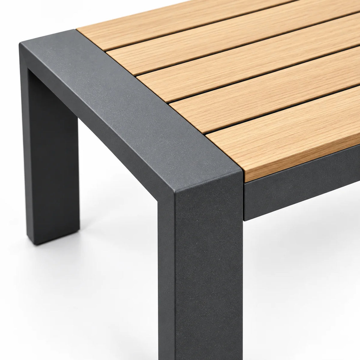Corner detail of outdoor aluminum patio coffee table with wood-look WPC slatted tabletop