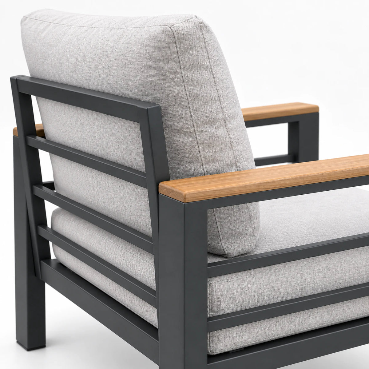 Back detail of outdoor sofa chair with gray cushion, black metal frame, and wood-look armrests